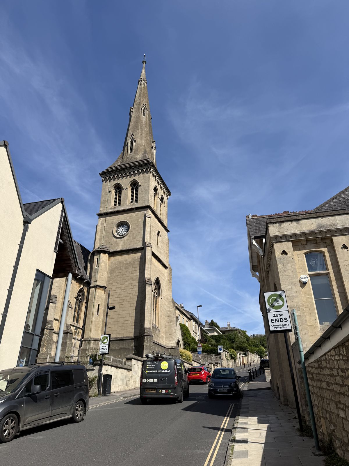 A honey-stone street in central Bath with a raised colonnaded podium